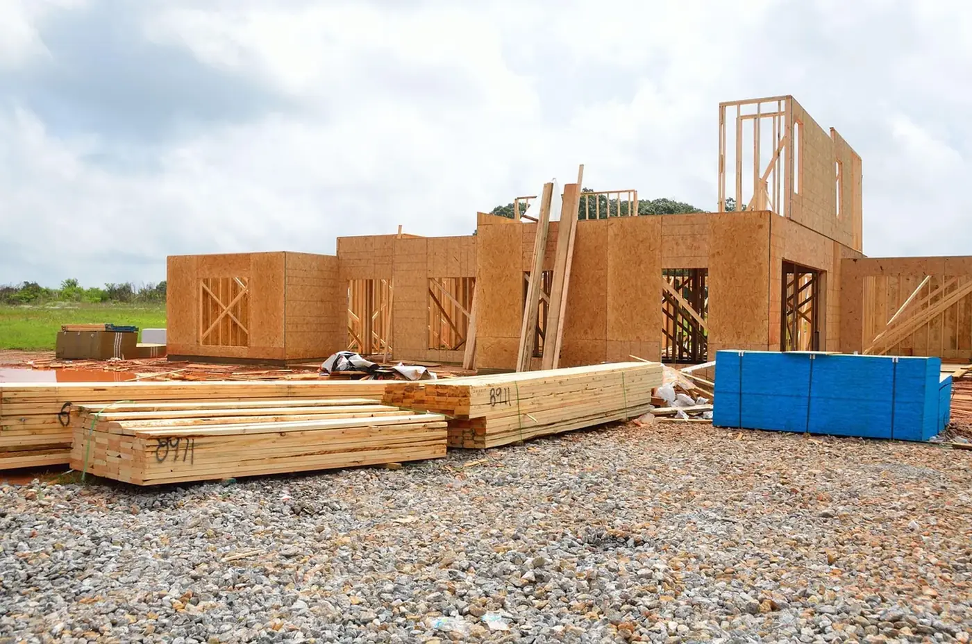 A house under construction with the timber frame going up.