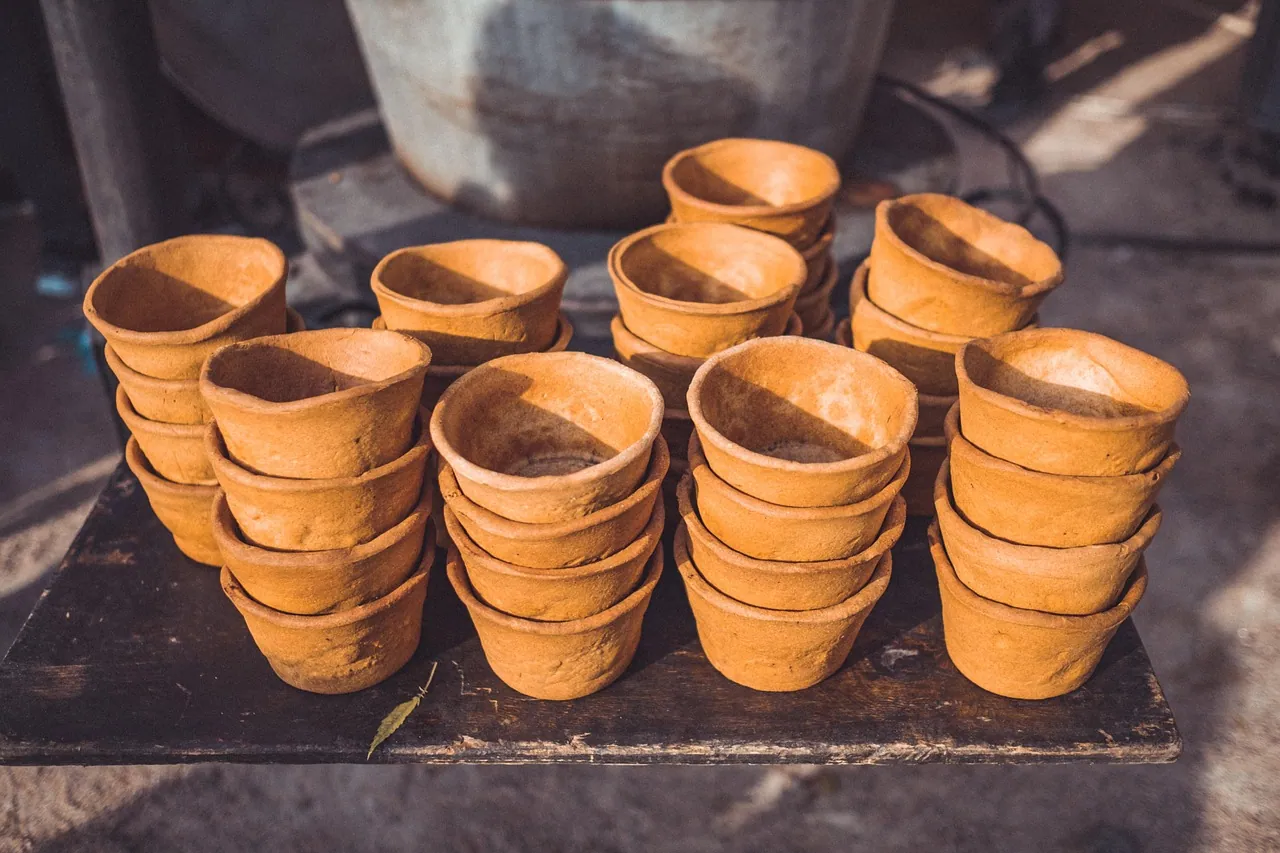 Rows of small handmade cups.