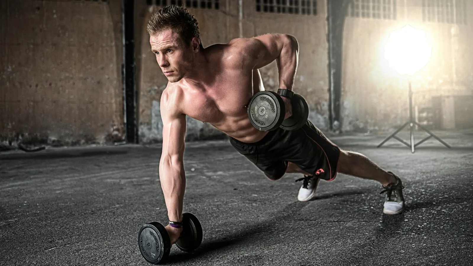 A member training with dumbbells.