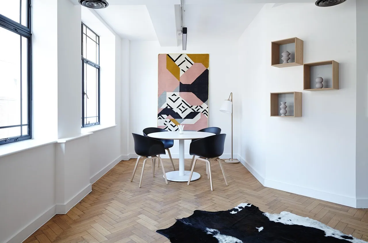 An empty apartment with wooden floors.