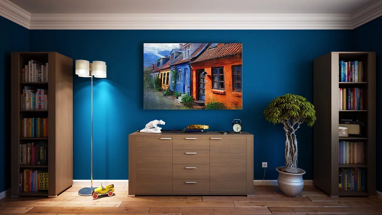 A living room with blue walls and bookshelves.
