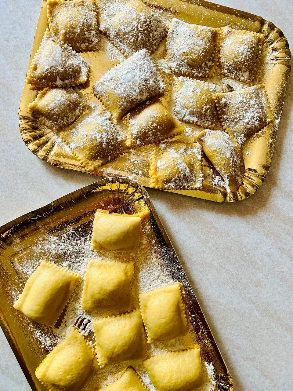 Fresh hand-made ravioli on a tray.