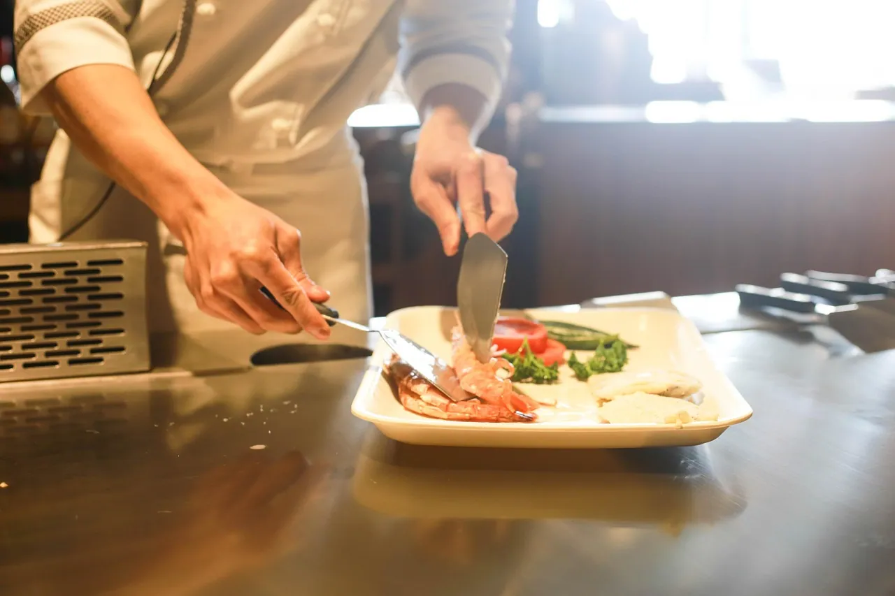 A plated main course being finished.