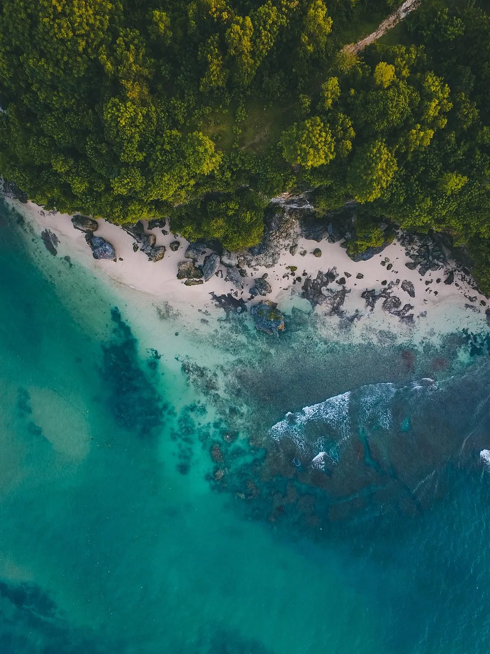 A long stretch of beach seen from above.