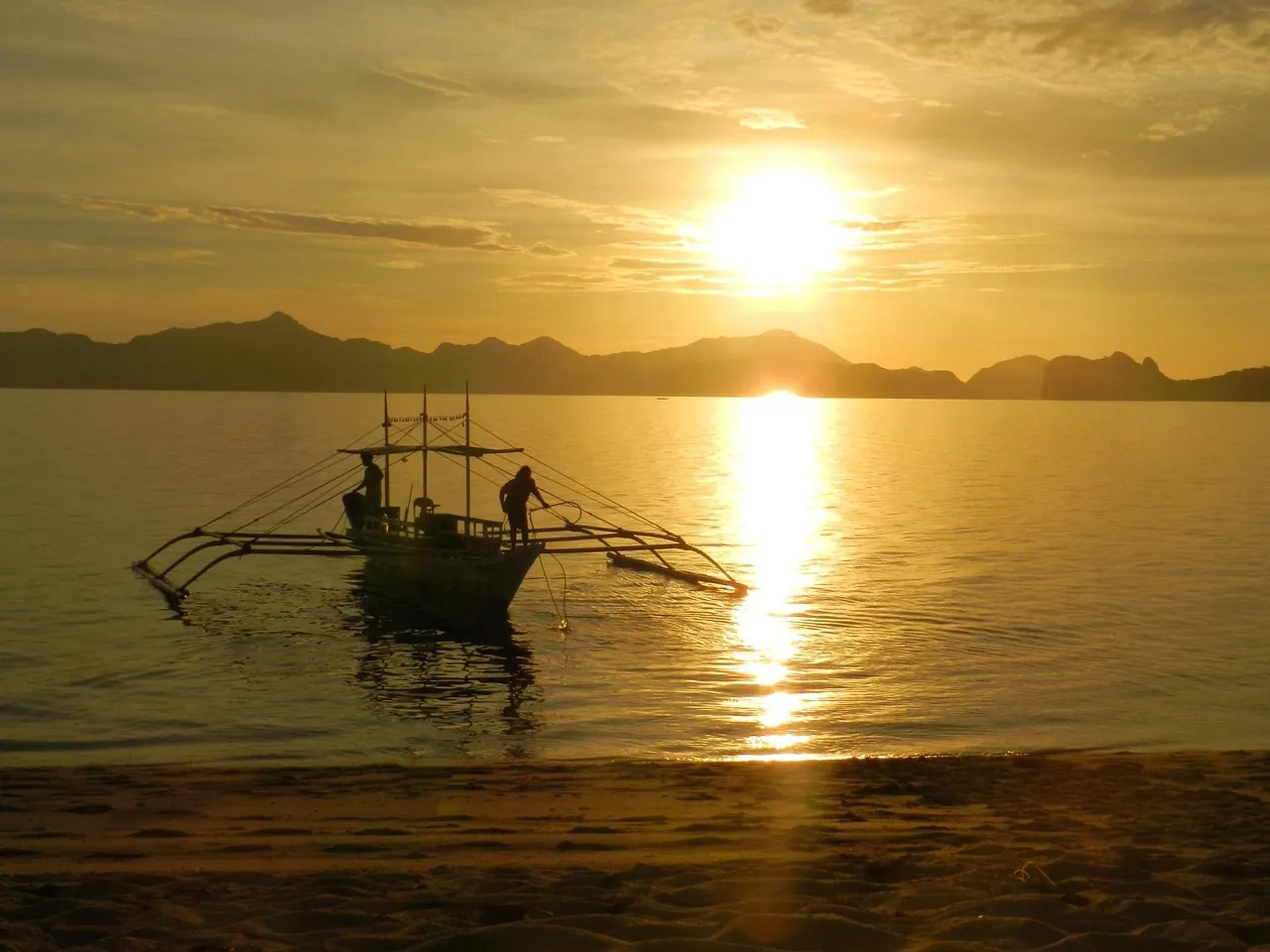A traditional boat at sunset.